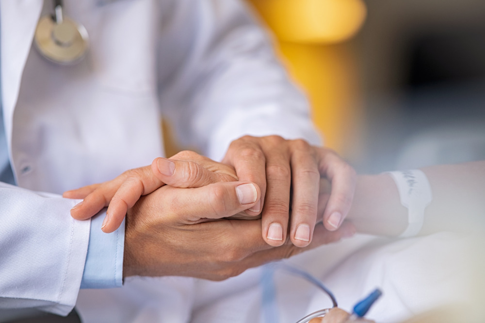 doctor holding patient's hand at hospital healthcare directives