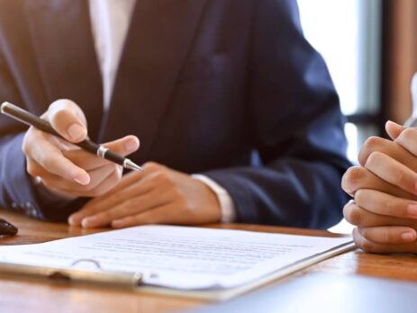 Estate planning attorney reviewing estate plan documents with female client | Fischetti Law Group