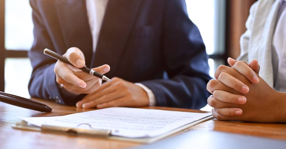 Estate planning attorney reviewing estate plan documents with female client | Fischetti Law Group