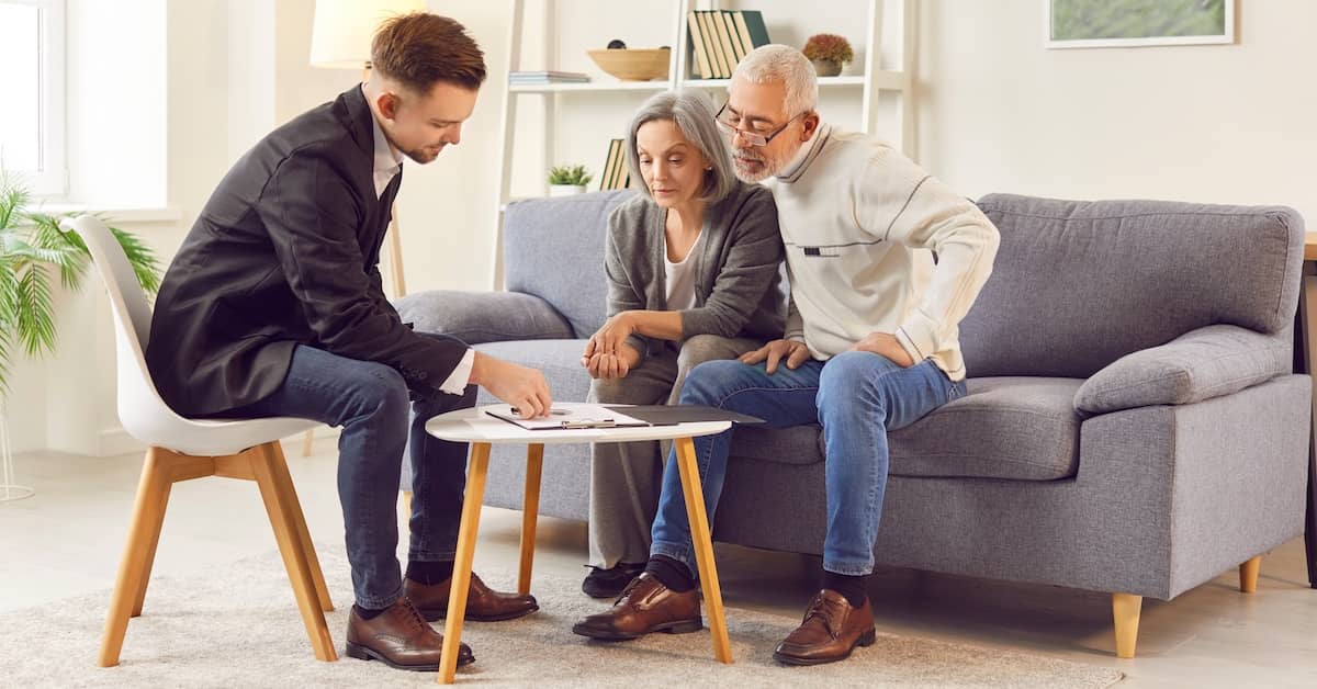 Elderly couple reviewing their will with estate planning lawyer | Fischetti Law Group